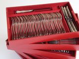 a lot of forks and spoons in a red box