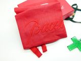 a red bag with the word peace on it next to a green cross