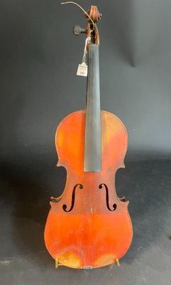 an old violin is sitting on top of a black surface