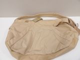 beige leather purse on a white table with a white background
