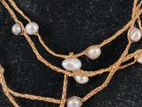 a close up of a necklace on a mannequin mannequin