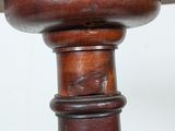 a bird sitting on top of a wooden table