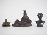 three bronze figurines of a woman and a cat