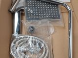 a box with a shower head and a hose in it