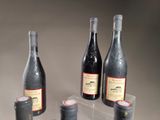 three bottles of wine sitting on top of a table next to each other