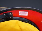 a fireman ' s hat with a tag attached to it