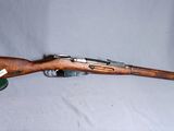 un vieux fusil avec un canon en bois et un étui vert