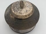 a small metal object on a white surface