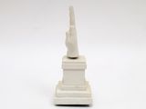 sculpture of a hand on a pedestal on a white background