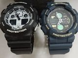 two watches sitting next to each other on a table