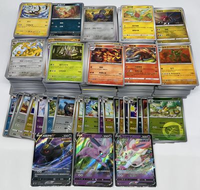 a lot of different pokemon cards on the table