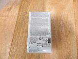 a box of toothpaste sitting on a wooden table
