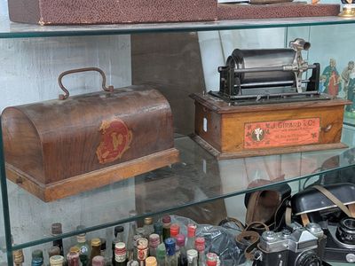 a glass display case with various items on it