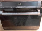 a black oven sitting on top of a wooden table