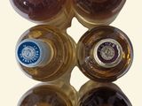 six bottles of wine sitting on top of each other