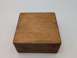 an old wooden box sitting on top of a white table