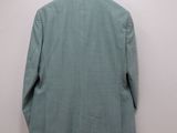 the back of a jacket hanging on a hanger on a wall