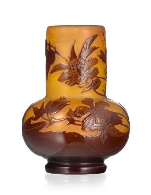 a brown vase with birds on it on a white surface