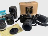 a camera, lens, camera case, and other items on the table