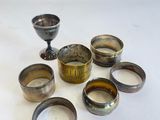 un ensemble de tasses et de bols en argent posés sur une table blanche