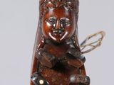 an image of a wooden sculpture of a woman holding a cat