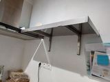 a microwave that is sitting on a shelf in a kitchen