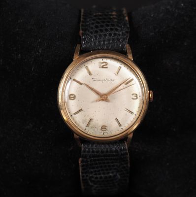 a close up of a wrist watch on a black cloth