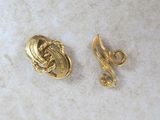 a pair of gold tone earrings with swirl design