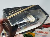 a person holding a box with a toy car inside of it