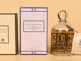 a bottle of perfume sitting next to a box
