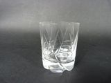 a glass with a toothpick in it on a table