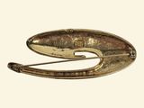 a close up of a gold brooch with a metal handle
