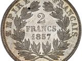 a silver coin with a laurel wreath on it