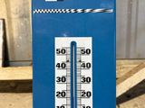 a thermometer that is on the side of a building