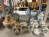 many different types of teapots and cups on the table