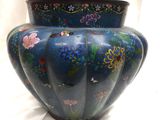 a blue vase with a floral design on it