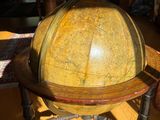 a large globe sitting on a wooden table in a living room
