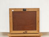an old wooden easel with a painting on top of it