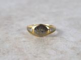 an image of a gold signet ring with a roman numeral