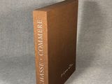 a brown book sitting on top of a table next to a gray wall