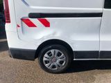 a white van with red stripes parked in a parking lot