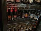 many bottles of wine on the shelves in the refrigerator