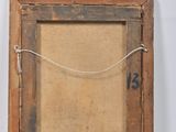 an old picture frame hanging on a wall with a string attached to it