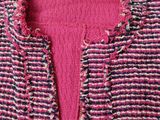 a close up of a pink jacket on a white background