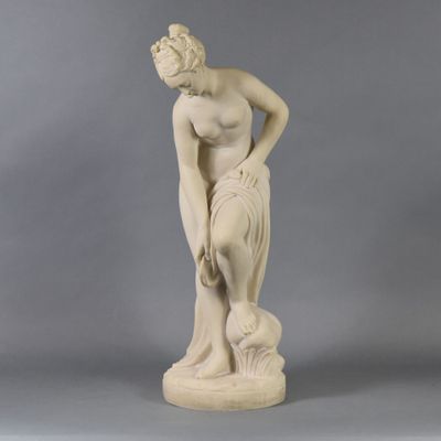 a statue of a woman with a dog on her lap