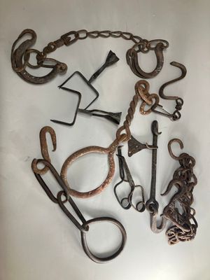 a lot of old metal tools on a white surface