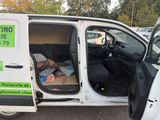 a white van with a green sign on the side of it