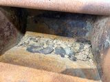 an old rusted oven with a hole in it