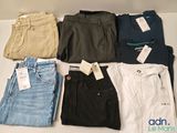 a lot of men ' s clothing on display on a table