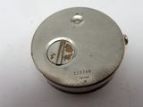 a close up of a metal object on a white surface